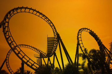blurred Roller coaster ride in amusement park at evening