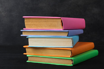 A stack of books on a dark background.