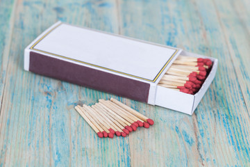 Red Matchbox on color wood background