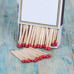 Red Matchbox on color wood background