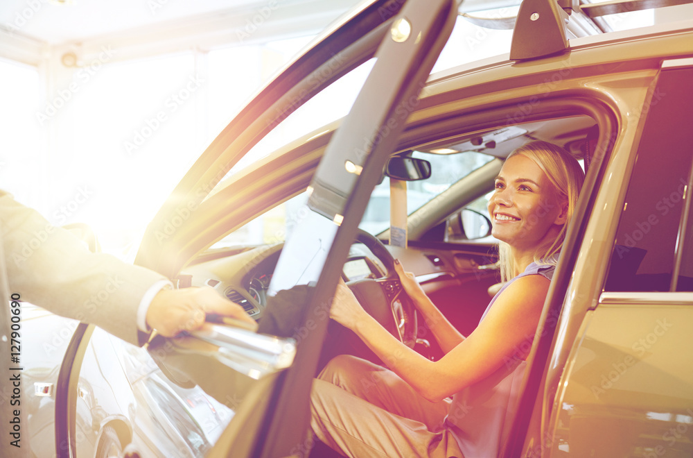 Sticker happy woman with car dealer in auto show or salon