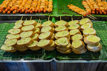 Barbeque outdoor butter garlic bread shop in the night market Thailand
