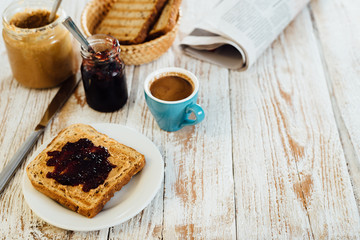 Homemade peanut butter and jelly sandwich on wooden background