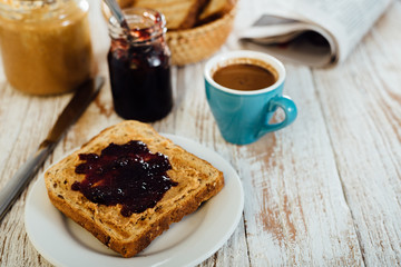 Fototapeta na wymiar Homemade peanut butter and jelly sandwich on wooden background
