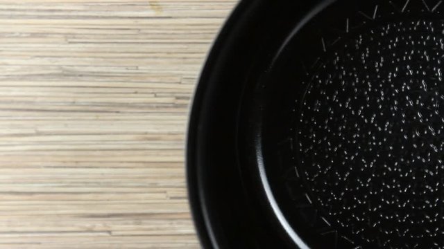 Frying pan on a wooden table background