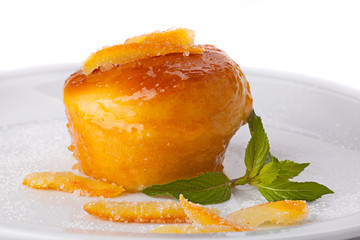 Italian sweet Baba of Naples with candied fruit and mint leaves.