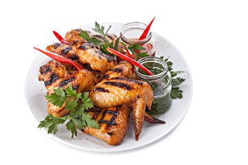 Plate of Grilled Chicken Wings with Sauce, isolated on white bac