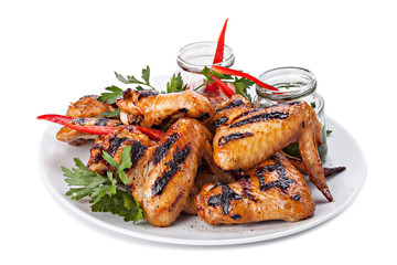 Plate of Grilled Chicken Wings with Sauce, isolated on white bac