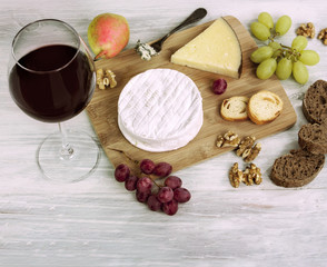 Red wine, cheese, grapes, nuts, with copyspace