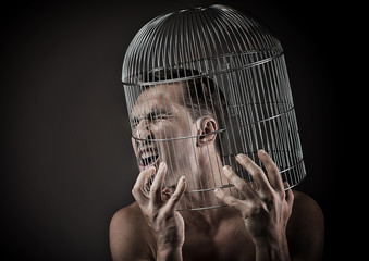Man with the head inside a birdcage, concept