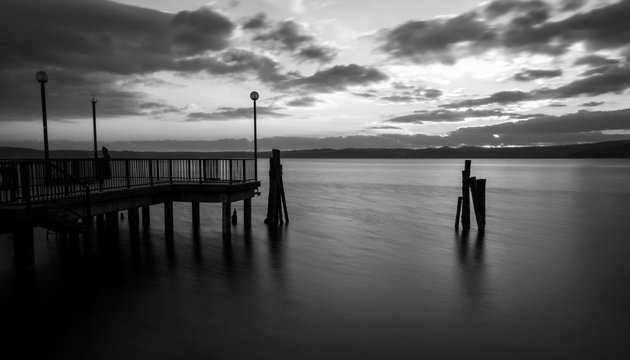 Sunset on Bracciano lake in Italy, long exposure in black and wh © puckillustrations