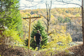 Man in black walks around autumn park