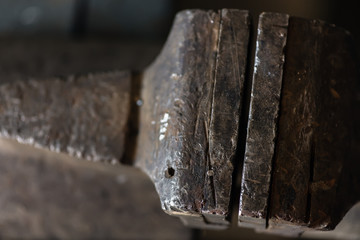 Closeup of vice tool clamping device on dark brown background