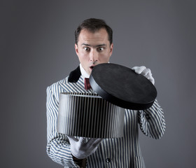 Surprised magician looking into a box