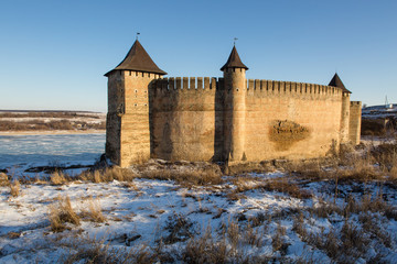 Ancient stone castle in winter. Landscape.
