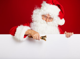 Photo of happy Santa Claus in eyeglasses looking at camera .