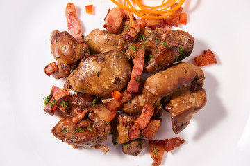 Stewed chicken livers with pork bacon and carrots