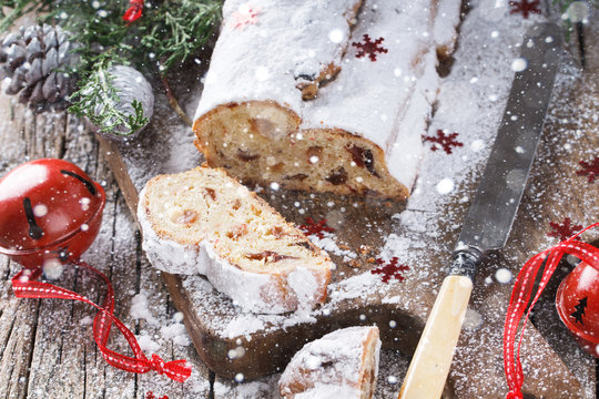 Dresdner Stollen is a Traditional German Cake with raisins.Gift for Christmas.Vintage style.Drawn Snowfall.selective focus