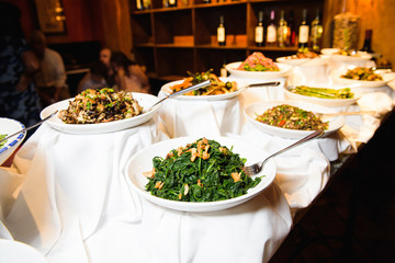 Tasteful salads served in white plates