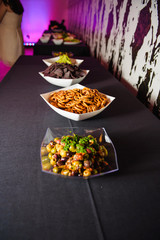 Salted cookies and snacks served in white plates on grey table