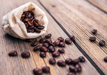 Coffee beans on the wooden background. Hot drinks.