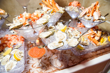 Mussels and other marine products served in large cocktail dishe