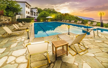 Fototapeta premium Beautiful sunrise over house and swimming pools