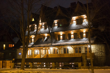 Traditional wooden cottage house on the street in Zakopane. 