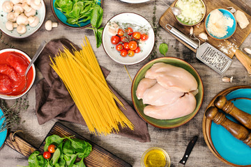 Raw Italian spaghetti with ingredients for preparing pasta