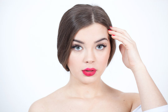 Beautiful Young Woman with Fresh Clean Skin touch own face. Red lips, red lipstick. Cosmetology, beauty and spa. 