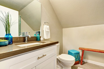 Fototapeta na wymiar Attic bathroom interior with new vanity cabinet