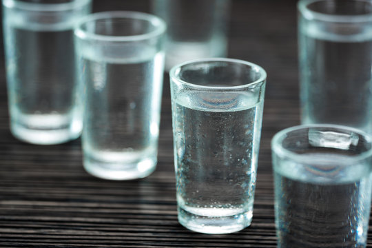 Shot glasses with vodka, selective focus