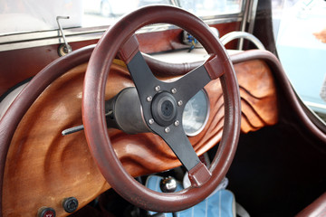 Wooden dashboard and steering wheel oldtimer car