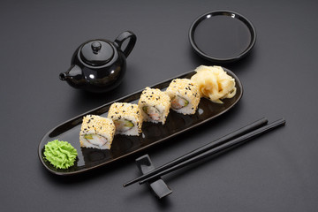 California sushi roll on a black plate