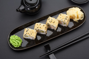 California sushi roll on a black plate