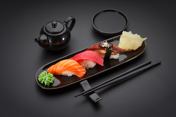 Tuna, salmon and eel sushi nigiri on the black table