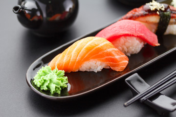 Tuna, salmon and eel sushi nigiri on the black table