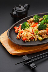 Japanese cuisine. Rice with vegetables over black background