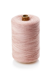 bobbin with pink thread isolated on a white background