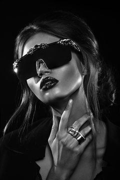 Studio portrait of attractive woman  wearing unusual sunglasses