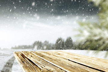 wooden desk space and winter landscape 