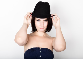Closeup portrait of beautiful sexy young woman in black hat, posing