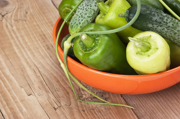 green peppers, cucumbers and garlic in a bowl