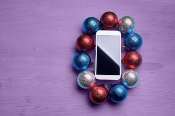 The wooden table with a phone and Christmas decorations.