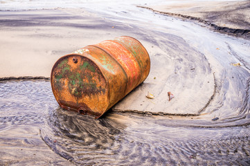 Old rusty barrel oil on beach