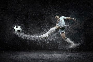 Splash of drops around football player under water