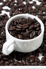 cups with coffee beans, closeup