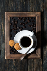 cup of black coffee on a tray, top view, vertical