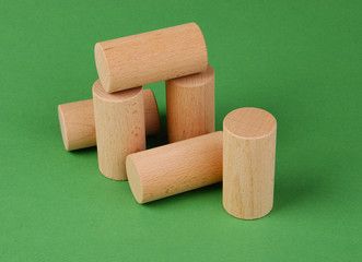wooden geometric shapes on a green background