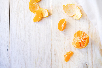 peeled tangerine on white boards